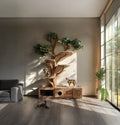 Handmade wooden cat tree tower with natural branches, leafy canopy, cushioned climbing platforms and cabinet-style base, displayed with cats in a modern living room.