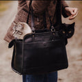 Luxury full\-grain leather pet carrier tote bag with a quilted interior and opening for a small dog or cat\.